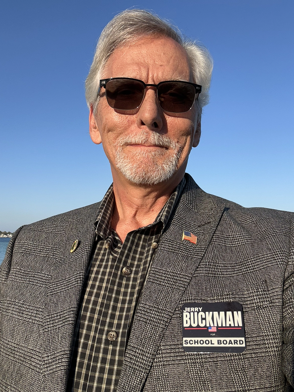 Jerry Buckman in a suit and sunglasses